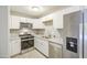Updated kitchen with white cabinets, stainless steel appliances, and neutral countertops at 7332 W Desert Cove Ave, Peoria, AZ 85345