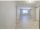 A living room with wood-look flooring, light grey walls and a fan and window at 7332 W Desert Cove Ave, Peoria, AZ 85345