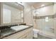 Bright bathroom featuring single sink vanity, walk-in shower with glass doors, and granite countertops at 7601 E Indian Bend Rd # 3002, Scottsdale, AZ 85250