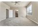 Open bedroom featuring light color walls, ceiling fan, and large window at 7601 E Indian Bend Rd # 3002, Scottsdale, AZ 85250