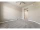 Carpeted bedroom featuring neutral colors, a ceiling fan, and a large window at 7601 E Indian Bend Rd # 3002, Scottsdale, AZ 85250