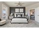 Modern main bedroom featuring neutral colors, dark accent wall, and a ceiling fan at 7601 E Indian Bend Rd # 3002, Scottsdale, AZ 85250