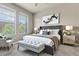 Staged main bedroom featuring large windows, bench seat, and stylish decor at 7601 E Indian Bend Rd # 3002, Scottsdale, AZ 85250