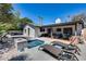 Inviting backyard featuring a sparkling pool, lounge chairs, and a covered patio for outdoor entertaining at 8625 E San Alfredo Dr, Scottsdale, AZ 85258