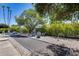 Secluded backyard area featuring a bocce ball court, mature trees, and comfortable seating for relaxation at 8625 E San Alfredo Dr, Scottsdale, AZ 85258