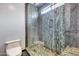 Modern bathroom showcasing a unique tiled glass shower, toilet, and contemporary fixtures at 8625 E San Alfredo Dr, Scottsdale, AZ 85258