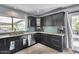 Well-equipped kitchen featuring sleek black cabinets, granite countertops, and stainless steel appliances at 8625 E San Alfredo Dr, Scottsdale, AZ 85258