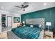 Spacious main bedroom featuring a padded headboard, rich green accent wall, walk-in closet, and refined furnishings at 8625 E San Alfredo Dr, Scottsdale, AZ 85258