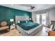 Luxurious main bedroom with a padded headboard, rich green accent wall, and elegant decor, creating a serene oasis at 8625 E San Alfredo Dr, Scottsdale, AZ 85258
