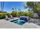 Secluded pool area surrounded by lush landscaping, featuring a charming waterfall and comfortable lounge chairs at 8625 E San Alfredo Dr, Scottsdale, AZ 85258