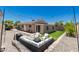 Inviting backyard featuring a comfortable seating area, lush artificial grass, and charming string lights at 902 E Wahalla Ln, Phoenix, AZ 85024