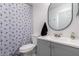 Bathroom featuring a vanity, round mirror, geometric shower curtain and tiled floor at 902 E Wahalla Ln, Phoenix, AZ 85024