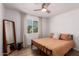 Bright bedroom with ample natural light, hard wood floors, and decorative mirror at 902 E Wahalla Ln, Phoenix, AZ 85024