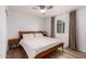Comfortable bedroom with a ceiling fan, wood-look flooring, and warm natural light at 902 E Wahalla Ln, Phoenix, AZ 85024