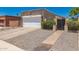 Charming home featuring stone accents, a two-car garage, and a welcoming gated entrance at 902 E Wahalla Ln, Phoenix, AZ 85024