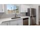 Modern kitchen with white cabinets, stainless steel appliances, and a bright, sunny window at 902 E Wahalla Ln, Phoenix, AZ 85024
