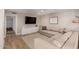 Comfortable living room with light wood floors, a large sectional sofa, and a ceiling fan at 902 E Wahalla Ln, Phoenix, AZ 85024