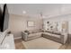 Cozy living room featuring a sectional sofa, a large TV, and modern decor at 902 E Wahalla Ln, Phoenix, AZ 85024