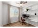 Home office space with lots of natural light, built in shelves, and wood-look flooring at 902 E Wahalla Ln, Phoenix, AZ 85024