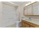 A clean bathroom features a shower-tub combo, toilet, and vanity with a mirror cabinet at 9434 W Greenway Rd, Sun City, AZ 85351