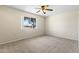 A cozy bedroom features a carpeted floor and a window providing natural light and an outdoor view at 9434 W Greenway Rd, Sun City, AZ 85351