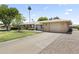 Charming single-level home with a well-maintained lawn and a spacious driveway leading to the garage at 9434 W Greenway Rd, Sun City, AZ 85351