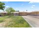 Inviting single-level home featuring a lush green lawn and a convenient attached garage at 9434 W Greenway Rd, Sun City, AZ 85351