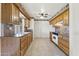 Functional kitchen with wooden cabinets and a clean white oven, ready for culinary adventures at 9434 W Greenway Rd, Sun City, AZ 85351