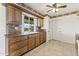 Kitchen with wood cabinets, offering a practical space for meal preparation and storage at 9434 W Greenway Rd, Sun City, AZ 85351