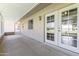 A covered patio extends the living space with multiple entry points, windows, and a screened area at 9434 W Greenway Rd, Sun City, AZ 85351