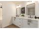 Bright bathroom featuring double sinks, modern fixtures, and framed mirrors at 9735 W Altadena Dr, Casa Grande, AZ 85194