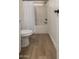 Bathroom with a wood-look flooring and black hardware on white doors at 9735 W Altadena Dr, Casa Grande, AZ 85194