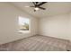 Bright bedroom filled with natural light, neutral carpet and desert views at 9735 W Altadena Dr, Casa Grande, AZ 85194