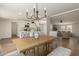 Open-concept dining room features modern table with seating and views into the living room at 9735 W Altadena Dr, Casa Grande, AZ 85194