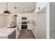 Modern kitchen with white cabinets, stainless steel appliances, and light countertops at 9735 W Altadena Dr, Casa Grande, AZ 85194