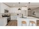 Bright kitchen with stainless steel appliances, white cabinetry, and eat-in island at 9735 W Altadena Dr, Casa Grande, AZ 85194