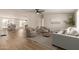 Bright living room features wood floors, neutral furniture, and seamless open-concept design at 9735 W Altadena Dr, Casa Grande, AZ 85194