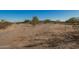 Wide, sprawling property featuring a desert landscape with sparse vegetation under a clear, blue sky at 9735 W Altadena Dr, Casa Grande, AZ 85194