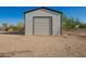 Metal workshop featuring a roll-up door on a sunny day at 9735 W Altadena Dr, Casa Grande, AZ 85194