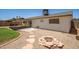 Backyard with covered patio, a patch of grass, and an outdoor fire pit with seating area at 9825 N 44Th Ave, Glendale, AZ 85302