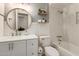 Bathroom featuring a dual sink vanity, large mirror, toilet and tiled bathtub with shower at 9825 N 44Th Ave, Glendale, AZ 85302