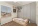 Bedroom with wood-look flooring, a window and toddler bed, accented by unique wall decor at 9825 N 44Th Ave, Glendale, AZ 85302