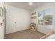 Bedroom with a window, a door, carpeted floors and a toddler's book stand at 9825 N 44Th Ave, Glendale, AZ 85302