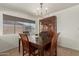 Inviting dining area featuring a wooden table, stylish chandelier, and a dark wood china cabinet at 9825 N 44Th Ave, Glendale, AZ 85302