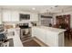 Well-lit kitchen featuring sleek countertops, stainless steel appliances, stylish lighting, and a dining area at 9825 N 44Th Ave, Glendale, AZ 85302