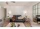 Cozy living room featuring comfortable seating, a large decorative mirror, and neutral decor at 9825 N 44Th Ave, Glendale, AZ 85302