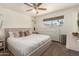 Serene main bedroom featuring a plush bed, soft lighting, and a view of the outdoors at 9825 N 44Th Ave, Glendale, AZ 85302