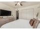 Inviting bedroom with a dresser, TV, closet, and a comfortable bed with decorative pillows at 9825 N 44Th Ave, Glendale, AZ 85302