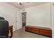 Spacious office featuring a dark wooden cabinet, carpeted floors and an open doorway at 9825 N 44Th Ave, Glendale, AZ 85302
