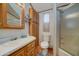 Bathroom with storage cabinets, a shower over tub, and a window for natural light at 111 S Greenfield Rd # 405, Mesa, AZ 85206